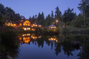 a house with a pond in front of it at night at A Hidden Haven Cottages in Port Angeles