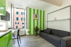 een woonkamer met groene en witte strepen op de muur bij La Casetta Verde con Vista Mare - Nel cuore del Parasio e delle Logge di Santa Chiara in Imperia