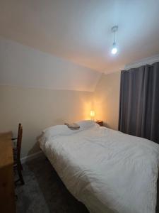 a bedroom with a white bed and a window at Cozy Guest Room in Colchester - Perfect for Travelers in Hythe