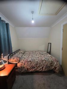 a bedroom with a bed and a dresser in it at Charming Colchester Room with Garden Views in Hythe +8 photos