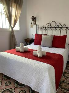 En eller flere senge i et værelse på Hostal Casa Blanca