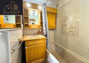 a bathroom with a sink and a bath tub at Chaleureux 2 chambres, Morillon in Morillon +22 photos