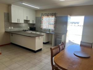 a kitchen with a table and a table and a dining room at 101 Maia in Gqeberha