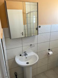a bathroom with a sink and a mirror at 101 Maia in Gqeberha