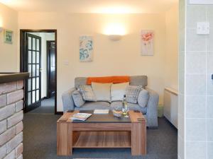 a living room with a couch and a coffee table at Ramscliff Cottage in Cheddar