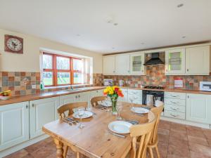 a large kitchen with a wooden table and chairs at The Parlour - Uk37517 in Routh