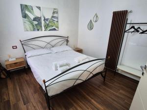 a bedroom with a bed with white sheets at Maison Alice in Alba