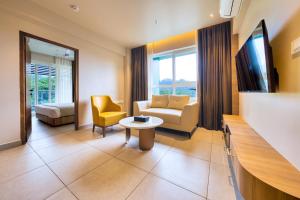 a living room with a couch and a table at MYSA Sky Suites, Lakkidi in Vythiri