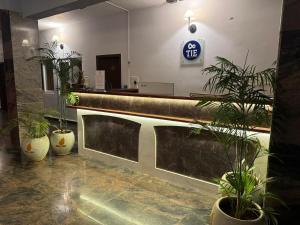 a lobby with potted plants and a reception counter at La Millionaire Luxury Resort - TIE Hotels & Resorts in Puducherry +77 photos