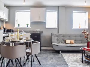 a kitchen and living room with a table and a couch at Apartment 2 - Uk50136 in Stoke on Trent