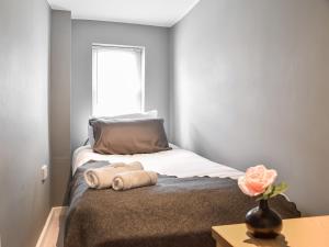 a bedroom with a bed with two towels on it at Apartment 2 - Uk50136 in Stoke on Trent +3 photos