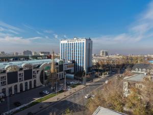 a view of a city with a tall building at Resident Hotel Abay in Almaty