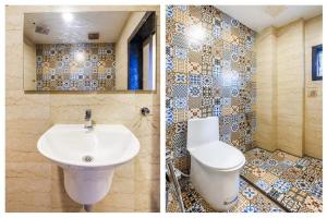 a bathroom with a sink and a mosaic wall at Hotel Keys Elite in Vijayawāda +24 photos