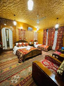 a large bedroom with two beds and a couch at Shanghai Palace in Srinagar