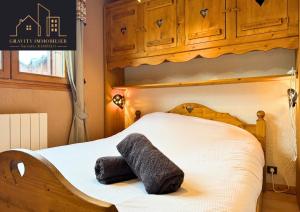 a bed with a stuffed animal on top of it at Chaleureux 2 chambres, Morillon in Morillon