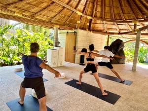 a group of people in a yoga class at Cape Pakarang Wow Wild Wellness Escapes in Khao Lak