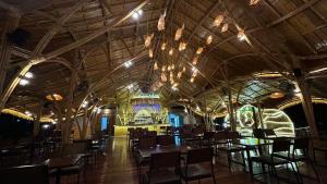 a dining room with tables and chairs in a building at Coco Valley Koh Tao in Ko Tao