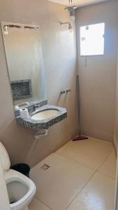 a bathroom with a sink and a toilet at Hotel Panorama Palace in Janaúba