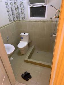 a bathroom with a toilet and a sink at Kourosh in Muscat