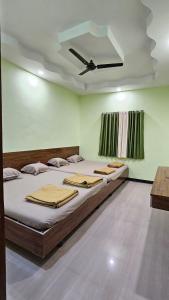 een groot bed in een kamer met een plafond bij Hotel Sai Pratham in Shirdi