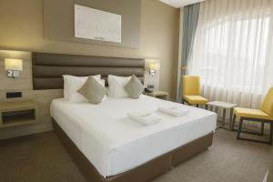Giường trong phòng chung tại Empire Hotel İstanbul