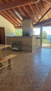 a large kitchen with a stove and a table at Rancho com acesso direto ao rio, área verde e lazer completo in Santa Fé do Sul