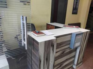 um escritório com uma mesa com um computador em cima em Hotel O Shakuntala Park Bus Terminus Behala em Behāla mais 5 fotografias
