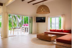 a living room with a couch and a table at Serene Jungle Escape with Private Pool by Sea N' Rent in Haad Chao Phao