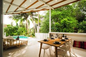 a patio with a table and chairs and a pool at Serene Jungle Escape with Private Pool by Sea N' Rent in Haad Chao Phao