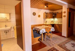 a kitchen with a table and a sink at Chalet Alpine Royal A Top 2 in Krimml +2 photos