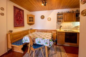 a kitchen with a table and a stove top oven at Chalet Alpine Royal A Top 2 in Krimml