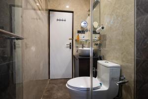 a bathroom with a toilet and a sink at Royale Enclave by JadeCapsNr.Manipal Hosp. in Ballygunge