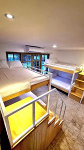 a bedroom with two bunk beds and a staircase at Casa Sakura Family Room in Calamba