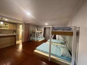 two bunk beds in a room with a kitchen at Casa Sakura Family Room in Calamba