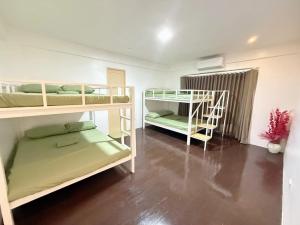 a room with two bunk beds and a staircase at Casa Sakura Family Room in Calamba