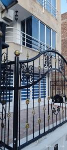 a black wrought iron fence with a staircase at Apartamento Limón Azul in Sogamoso +21 photos