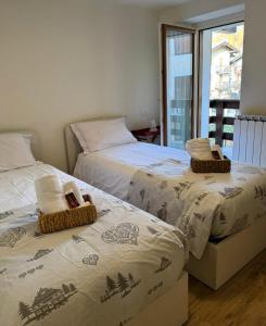 two beds sitting next to each other in a bedroom at Sant'Orso Cozy Home in Cogne