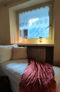 a window in a room with a couch in front of it at Sant'Orso Cozy Home in Cogne
