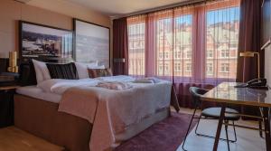 a woman laying on a bed in a hotel room at Marski by Scandic in Helsinki +66 photos