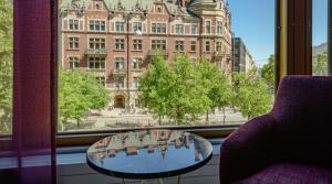 a room with a table and a window with a building at Marski by Scandic in Helsinki