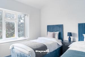 Ένα ή περισσότερα κρεβάτια σε δωμάτιο στο Spacious 4-bed Home Near Didsbury