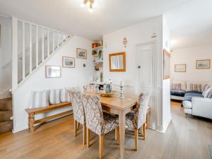 a dining room with a table and chairs and a couch at Toll Bar Cottage in Whitby