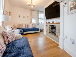 a living room with a couch and a fireplace at Toll Bar Cottage in Whitby
