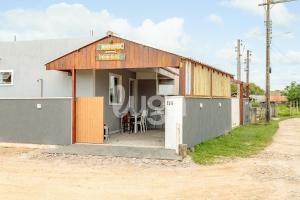 a small building with a table and chairs outside at LUGA: Peaceful Retreat | Lagoon & Imbituba in Imbituba