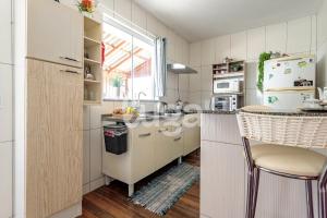 a kitchen with white appliances and a counter top at LUGA: Peaceful Retreat | Lagoon & Imbituba in Imbituba