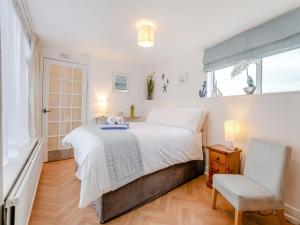 a bedroom with a large bed and a window at Toll Bar Cottage in Whitby +28 photos