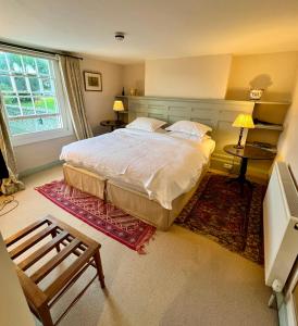 a bedroom with a large bed and a window at Lamb Inn in Wartling