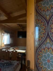 a room with a wall with a colorful pattern on it at Domek drewniany in Piekielnik +23 photos