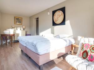 a bedroom with a bed and a couch at Luxury Pool Villa in Sosoye in Sosoye