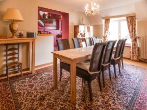a dining room with a wooden table and chairs at Luxury Pool Villa in Sosoye in Sosoye